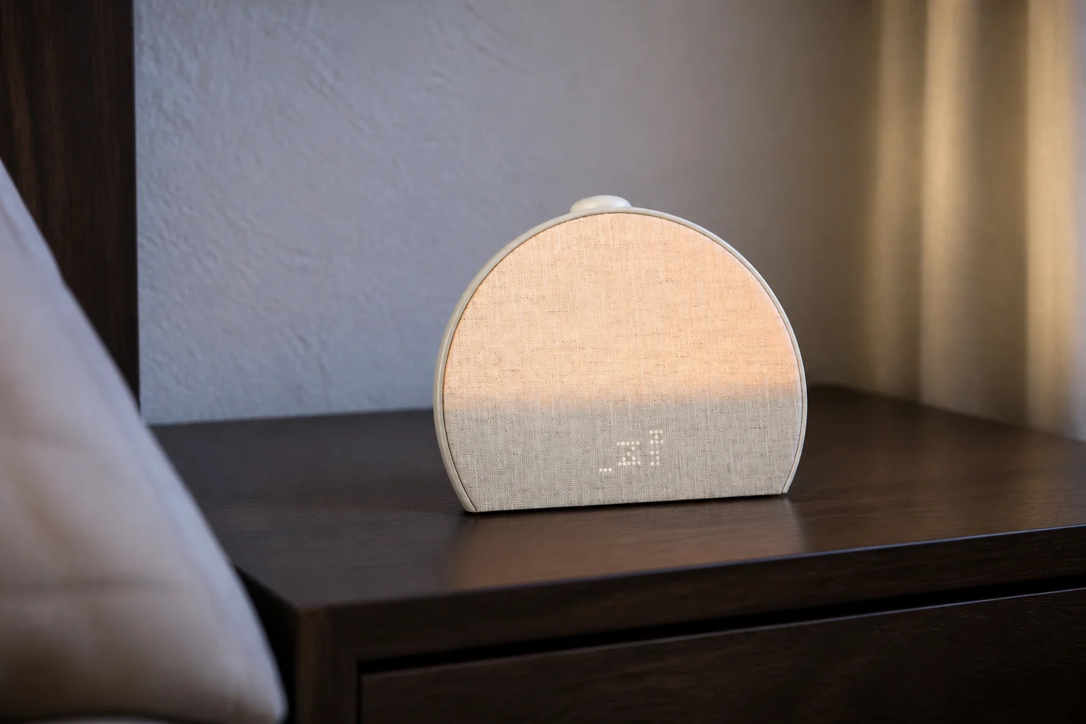 Hatch Sleep Clock with contactless sleep tracking on a dark oak nightstand